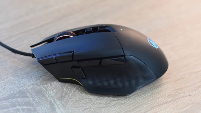 The AOC Agon AGM600 gaming mouse on a desk.
