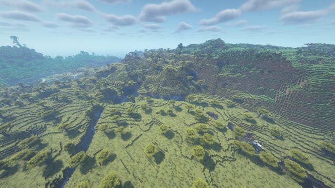 A small mountain range in Minecraft, with a ravine carved into the foreground.