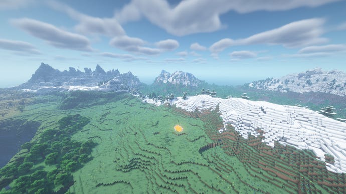 A Minecraft landscape of plains and trees, with snow-capped mountains in the distance.