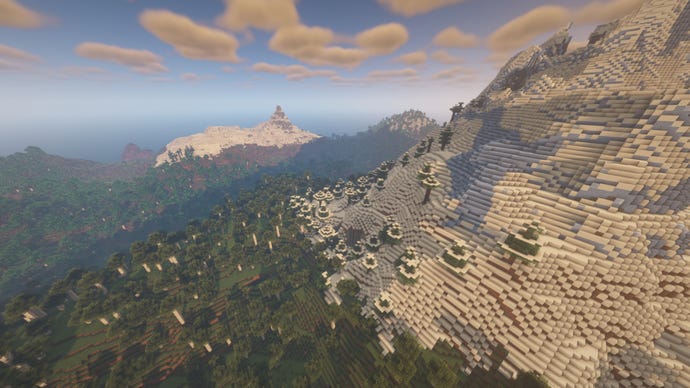 A Minecraft landscape with a giant snow-covered mountain on the right towering over the forest on the left.