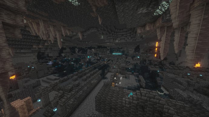 A large underground Ancient City in Minecraft, with Dripstone stalactites in the foreground.